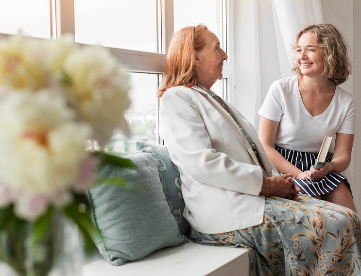 Family caregiver taking a peaceful rest while professional caregiver attends to their loved one